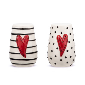 A set of white ceramic salt and pepper shakers. Each has a raised red heart on the front and either black dots or lines on the outside.