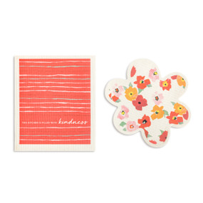 Two red and white biodegradable dish cloths. One is flower shaped with illustrated flowers and the other is red with the saying "This kitchen is filled with kindness".