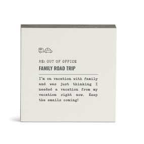 A white square wall art with the saying "RE: Out of Office Family Road Trip" with a short write up about someone on a family vacation.