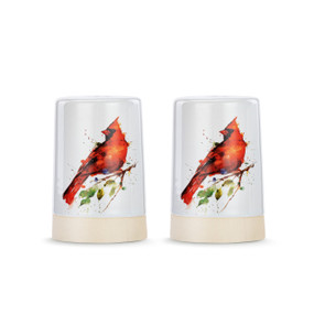 A set of two white ceramic salt and pepper shakers with a cream textured base. There is a watercolor image of cardinals on them.