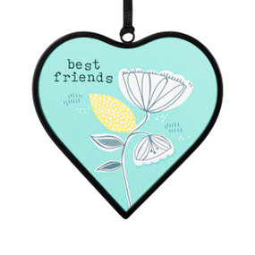 A small light green heart shaped sun catcher with a floral illustration and the saying "best friends".