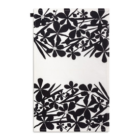 A white kitchen towel with illustrations of large bold black flowers displayed with the towel laid out flat.