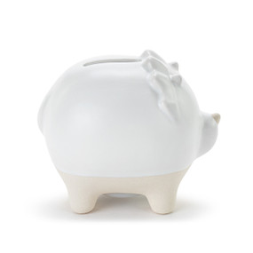 A white ceramic piggy bank with the face and ridges of a dinosaur. The feet of the bank are cream and textured.