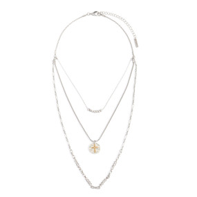 An adjustable silver chain necklace with three layers including beads and a round silver charm with a gold cross.