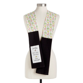 A white illustrated baking themed fabric kitchen boa with black towel ends and a fabric patch with the saying "Friends who Cook Together Stay Together", displayed on a mannequin.