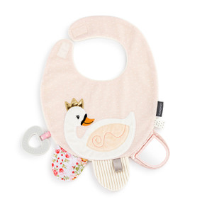 A light pink baby bib with a swan appliquéd on top. The bib has sensory tabs at the bottom and a teether ring attached.