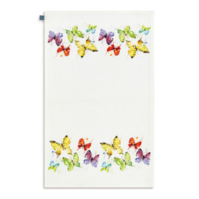 A white kitchen towel with watercolor images of colorful butterflies, displayed laid out flat.