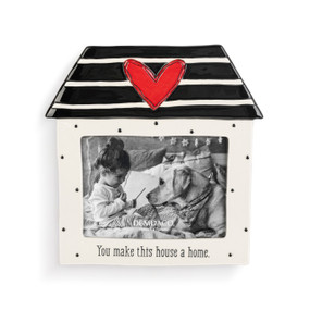 A cream and black house shaped ceramic photo frame. It has a red heart on the roof and the bottom says "You make this house a home".