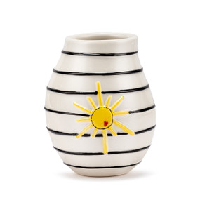 A white ceramic vase with black horizontal stripes and a raised yellow sun on the front.