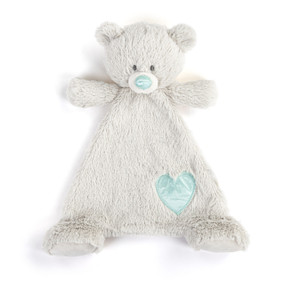A cream blankie with the face of a bear that has an aquamarine colored nose. The blankie has an aquamarine colored fabric heart shaped patch near the foot.