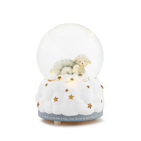 A musical snowglobe with two lambs and stars inside. The base looks like a white cloud with gold stars.
