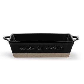 A black ceramic loaf dish with handles on the short ends and a tan textured base. The front of the loaf pan says "Warm & Toasty".