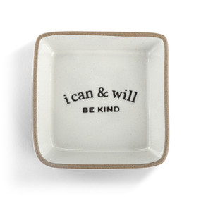 A square cream ceramic trinket dish with a tan textured rim that says "i can & will Be Kind" on the inside.