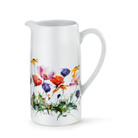 A white ceramic handled pitcher with a watercolor image of colorful wildflowers around the pitcher.