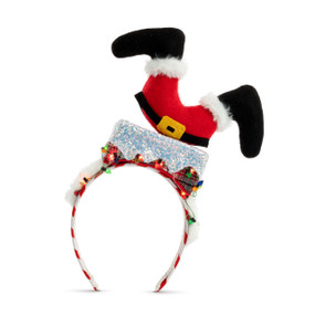 A silly lit holiday headband with Santa going heads down a chimney on top.
