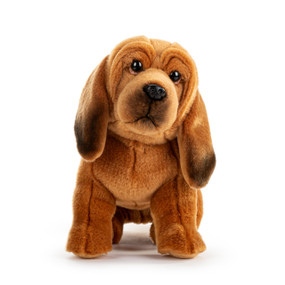 A brown and black plush bloodhound sitting down.