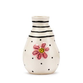 A white ceramic vase with black horizontal lines and dots with a raised pink flower on the front.