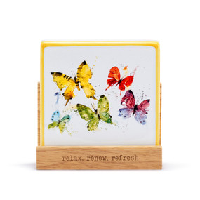 A square oil diffuser with a watercolor image of colorful butterflies on it set in a wood stand that says "relax, renew, refresh".