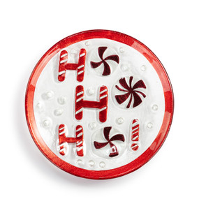 A mini round glass plate that says "Ho Ho Ho" in the shapes of peppermints and a red rim.
