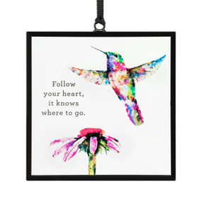 A square suncatcher with a watercolor hummingbird, a flower and the saying "Follow your heart, it knows where to go".