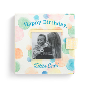 A cream fabric photo book with pastel polka dots. There is a photo holder on the front and the book says "Happy Birthday, Little One!".