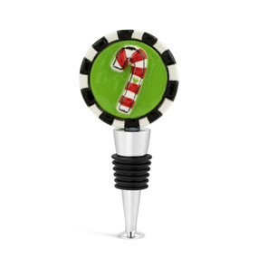 A silver and black bottle stopper with a green ceramic circle on top with a candy cane.
