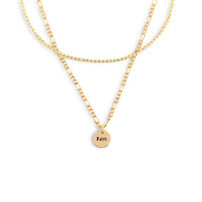 A layered necklace made of a gold chain with a round gold charm that says "Faith" and a layer of gold and white small beads.