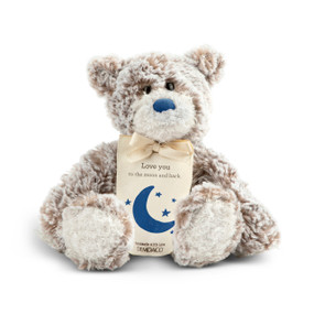 A gray and brown plush bear with a blue nose and a cream tag tied around its neck that says "Love You to the moon and back" with a blue moon and stars.