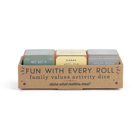 A set of three wood dice painted green, yellow and gray that have different faith activities on each side, displayed in a cardboard box.