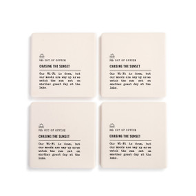 A set of four white ceramic coasters with the saying "RE: Out of Office Chasing the Sunset" with a short write up about someone watching the sunset at the lake.