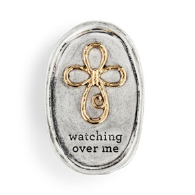 An oval silver metal visor clip with the image of a cross in gold and the saying "watching over me".
