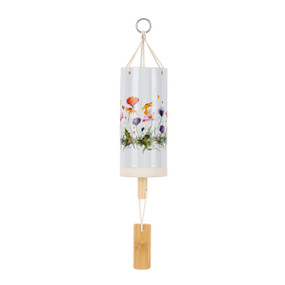 A white tubular ceramic wind chime with a wood chime. There are colorful wildflowers around the outside.