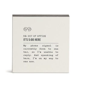 A white square wall art with the saying "RE: Out of Office It's 5:00 Here" with a short write up about someone in a bar.