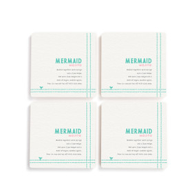 A set of four white square coasters with a basic recipe for a Mermaid Mojito written in green.