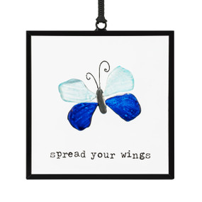 A small square suncatcher with a blue butterfly made out of small colored stones and the saying "spread your wings".