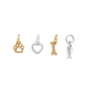 A set of four different gold and silver charms about pets.