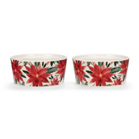 Two white ceramic ramekins with a red poinsettia floral pattern on the outside, displayed at an angle to show the lip on the inside rim allowing them to stack.