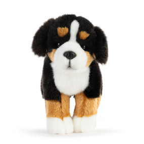 A white, tan and black plush Bernese Mountain dog standing up.