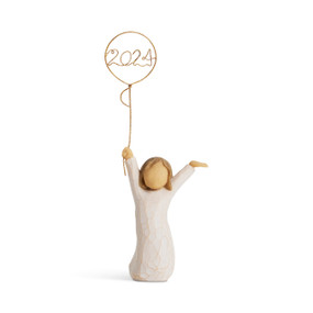 Front view: standing figure in cream dress, arms raised, holding gold wire balloon with 2024 written in gold wire inside