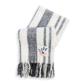 A gray and white stripe fringed blanket. There is a fabric patch with a watercolor flower and butterflies in the bottom right corner.