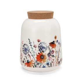 A medium sized white ceramic container with a cork lid. The container has illustrated meadow flowers.