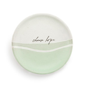 A small round ceramic trinket dish with light green on the bottom half with the saying "choose hope" in the middle.