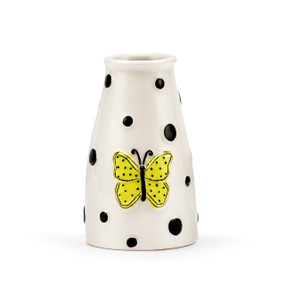 A white ceramic vase with black polka dots and a raised yellow butterfly on the front.