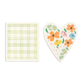 Two green and white biodegradable dish cloths. One is heart shaped with illustrated flowers and the other is white and green plaid.