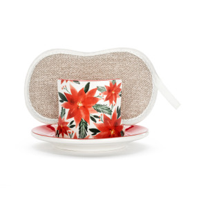 A white ceramic soap dish with a red poinsettia illustration and a tan sponge in the open slot.