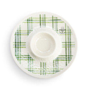 Top down view of a round chip and dip plate with a green plaid pattern.