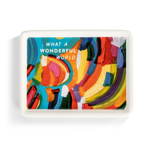 A white ceramic mini tray with artwork created by ArtLifting artist Matthew Breedlove. The image is colorful paint lines and says "What A Wonderful World" at the top left.