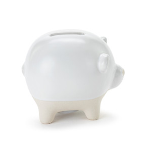 A white ceramic piggy bank with the face and ears of a bear. The feet of the bank are cream and textured.