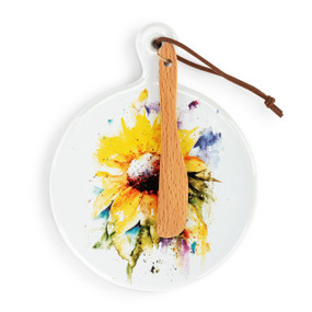 A round ceramic white mini serving board with a watercolor sunflower. The board has a small wood knife attached.