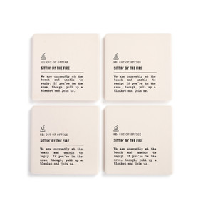 A set of four white ceramic coasters with the saying "RE: Out of Office Sittin' by the Fire" with a short write up about someone sitting by a fire on the beach.